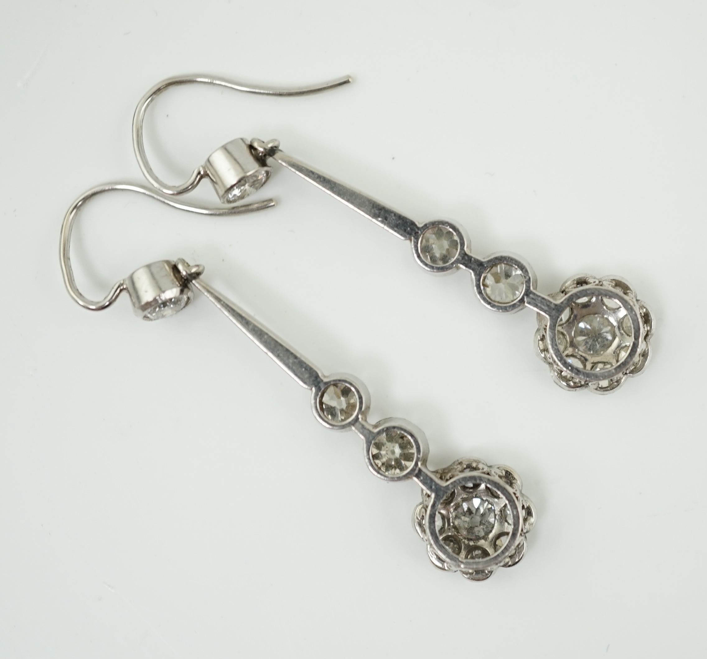 A pair of 1920's style platinum? and millegrain set diamond cluster drop earrings